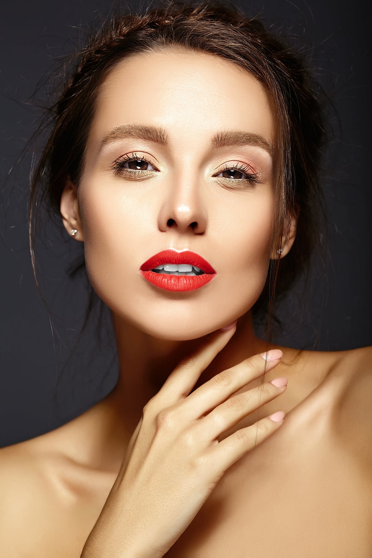 Simple makeup look with softly defined eyes, natural brows and bright red lipstick