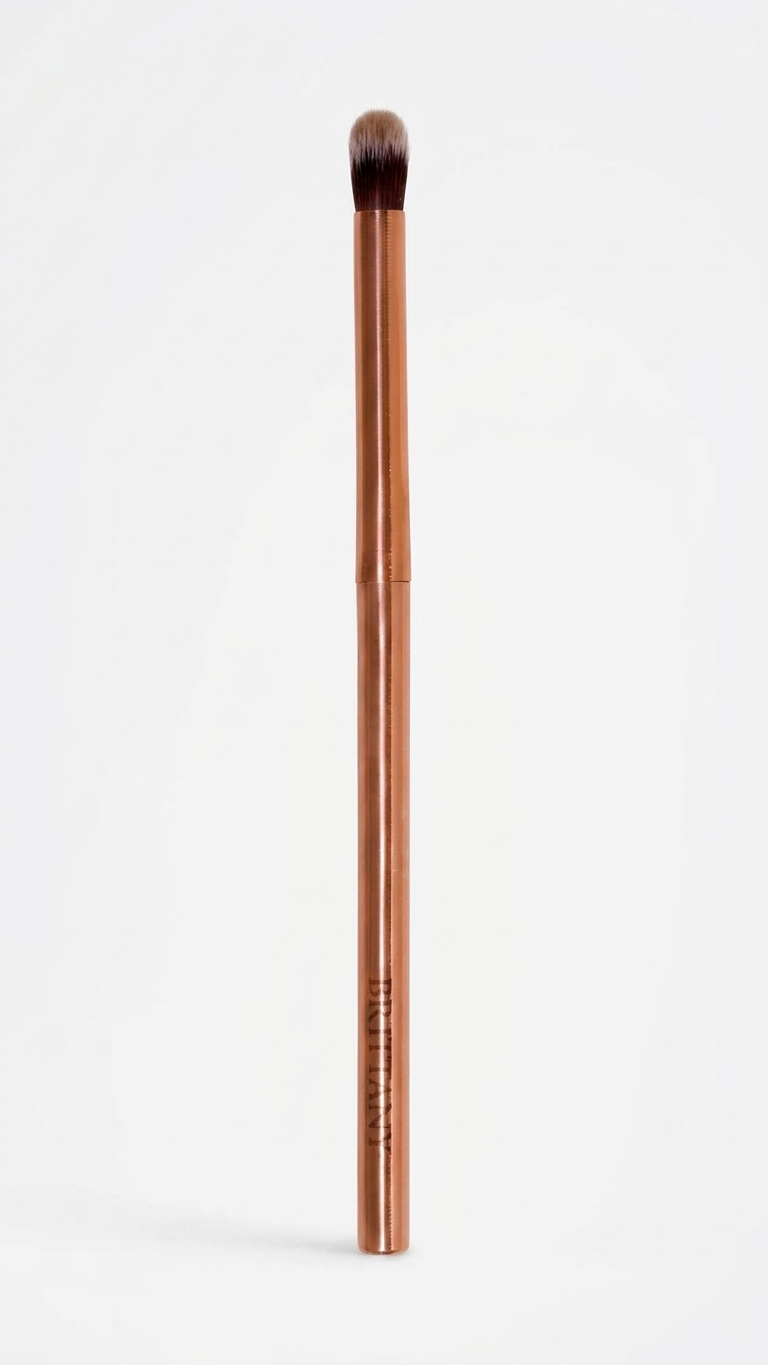 Blending brush with dark brown bristles and rose-gold slim handle